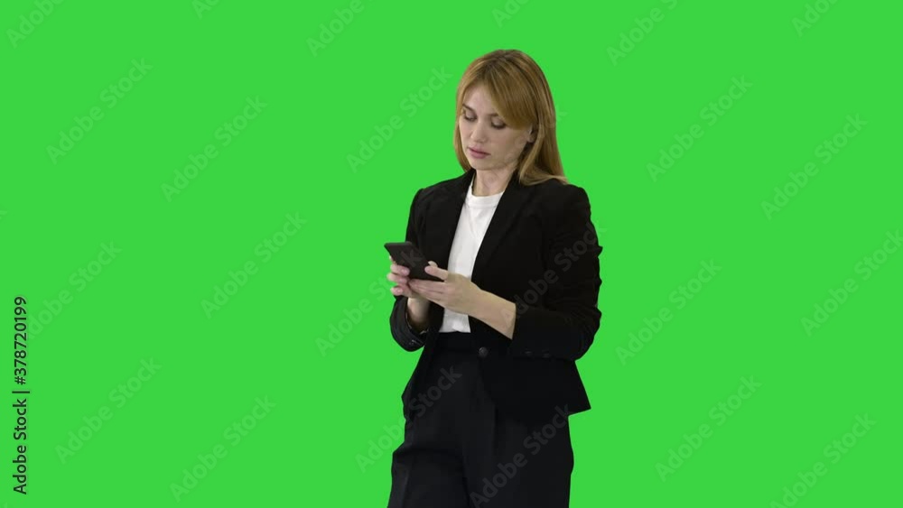 Beautiful and happy, smiling young business woman interact with phone application on a Green Screen, Chroma Key. Beautiful and happy, smiling young business woman interact with phone application on a Green Screen, Chroma Key.