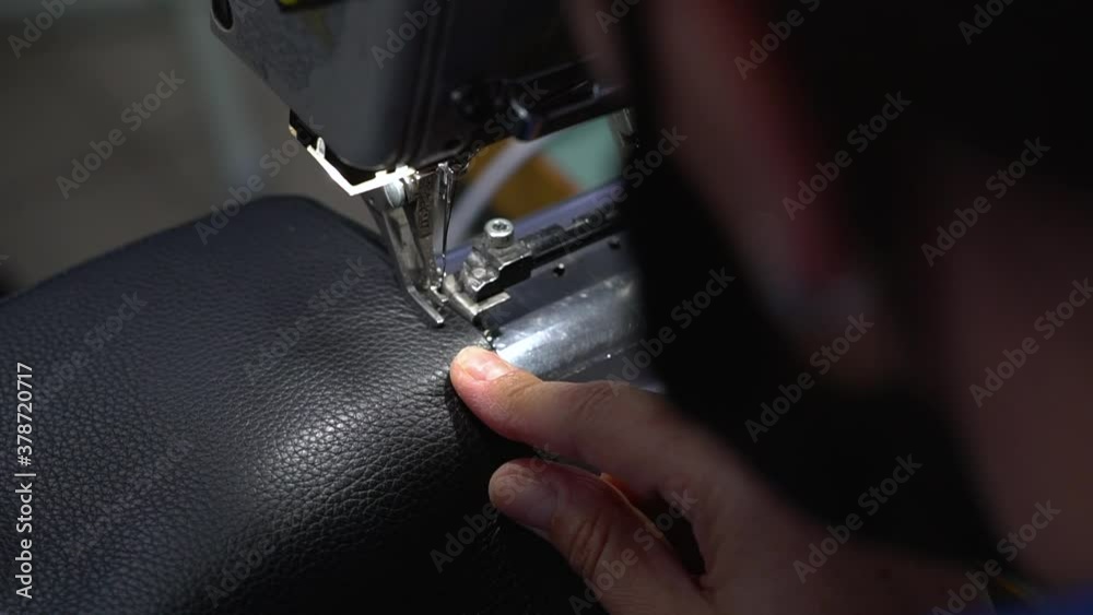 Close up of a woman sewing on the sewing machine