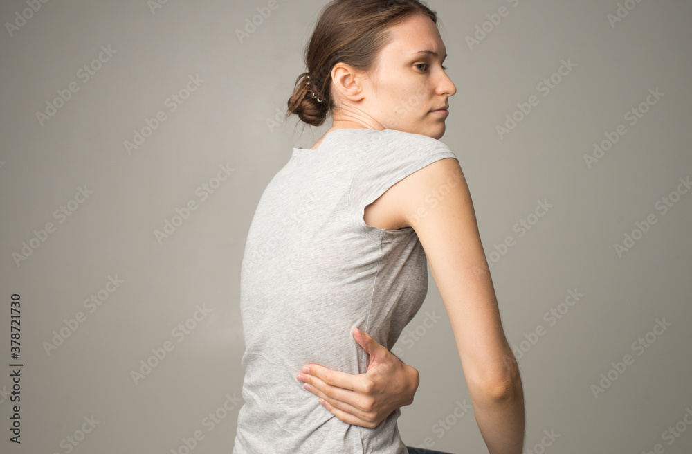Obraz premium Tired woman feeling pain, massaging tense muscles