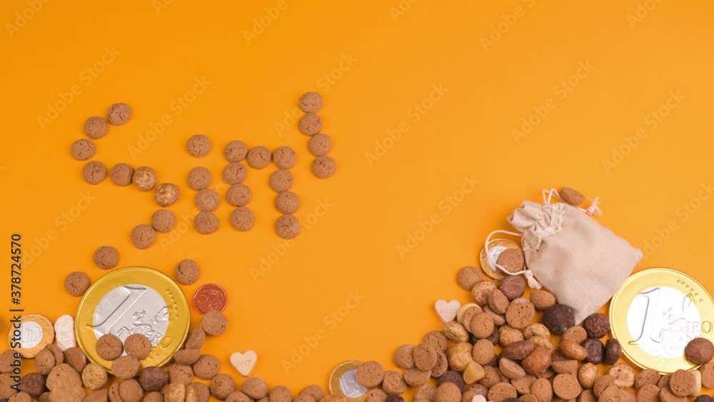 St. Nicholas Day background. Card. Dutch holiday Sinterklaas flat lay with gifts, pepernoten, traditional sweets strooigoed. Holiday greeting card . stop motion