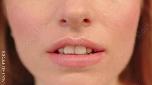 Lower Face Of A Woman Facing Closely At The Camera With Mouth Slightly Open - Extreme Closeup Shot