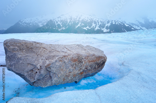 Top of Mendenhall glacier and huge boulders with melted ice under them in Juneau Ice field, Alaska photo