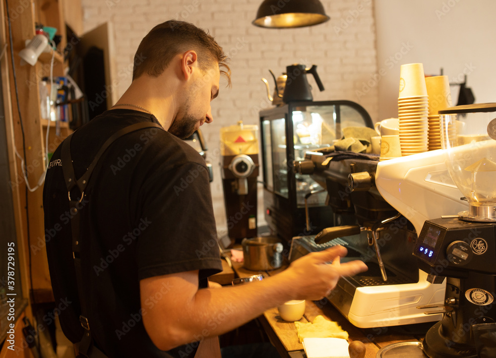 Barista preparing coffee at cafe.