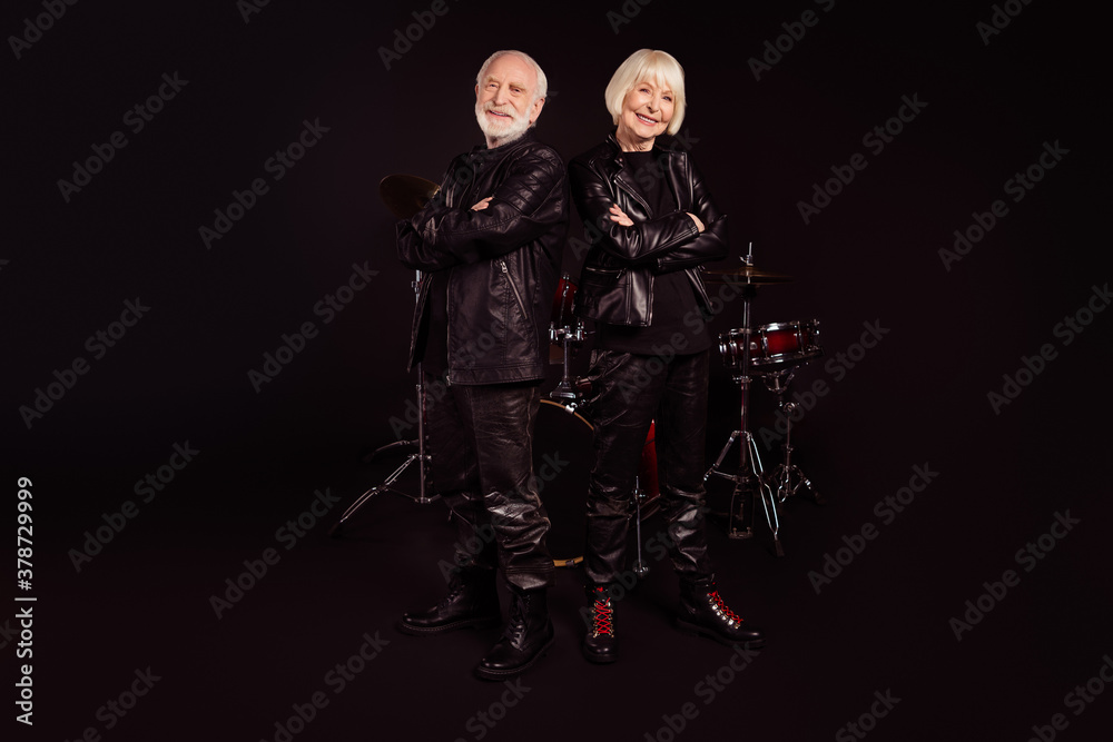Obraz premium Photo of two pensioners people family cool aged lady man rock band group all life together concert show drum instruments wear trendy rocker leather outfit isolated black color background