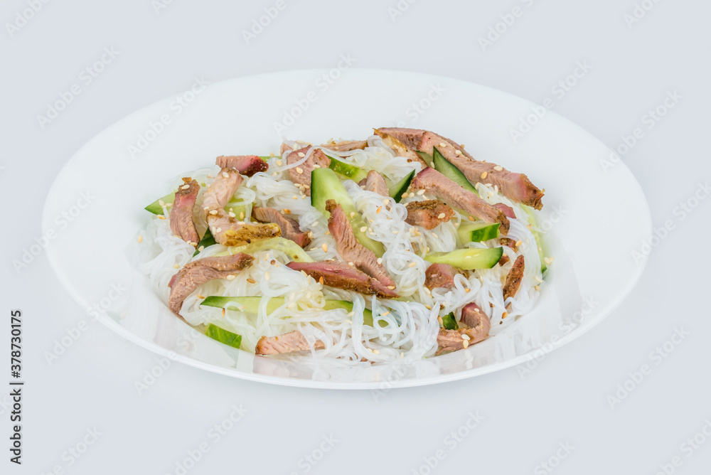 Funchose salad with meat in a white plate Funchose salad with meat in a white plate