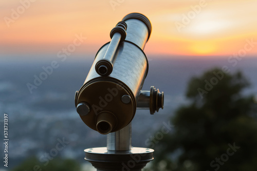 coin telescope at a view point at sunset photo