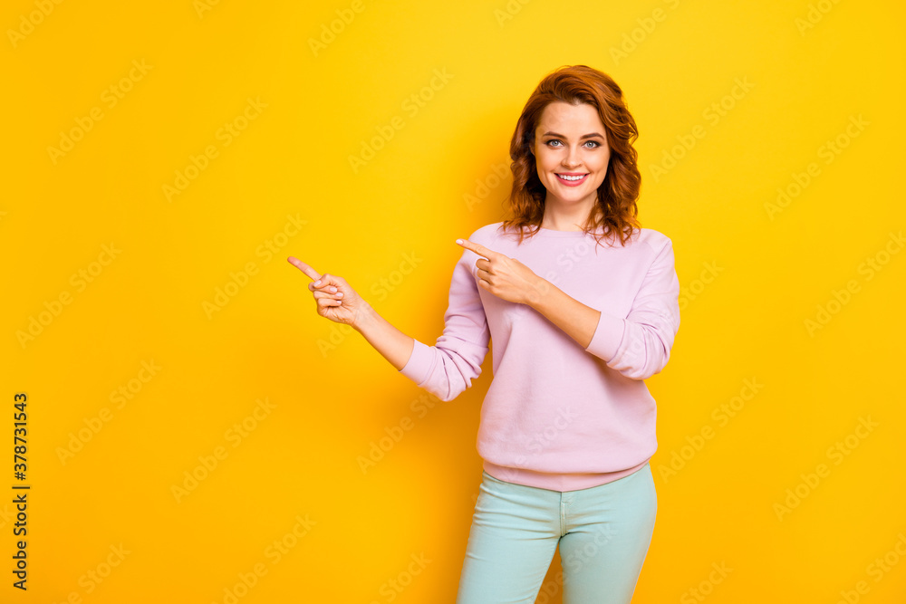 Photo of amazing pretty lady indicate fingers empty space advising novelty product sale low prices wear pink pullover green trousers isolated yellow color background Photo of amazing pretty lady indicate fingers empty space advising novelty product sale low prices wear pink pullover green trousers isolated yellow color background