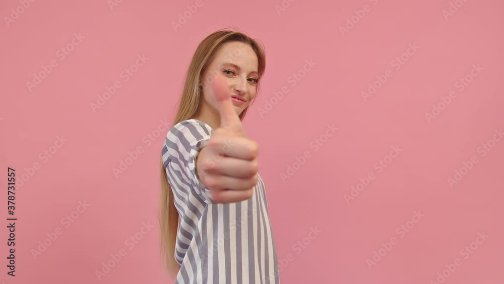 Young caucasian woman showing thumb up, isolated on pink background Young caucasian woman showing thumb up, isolated on pink background
