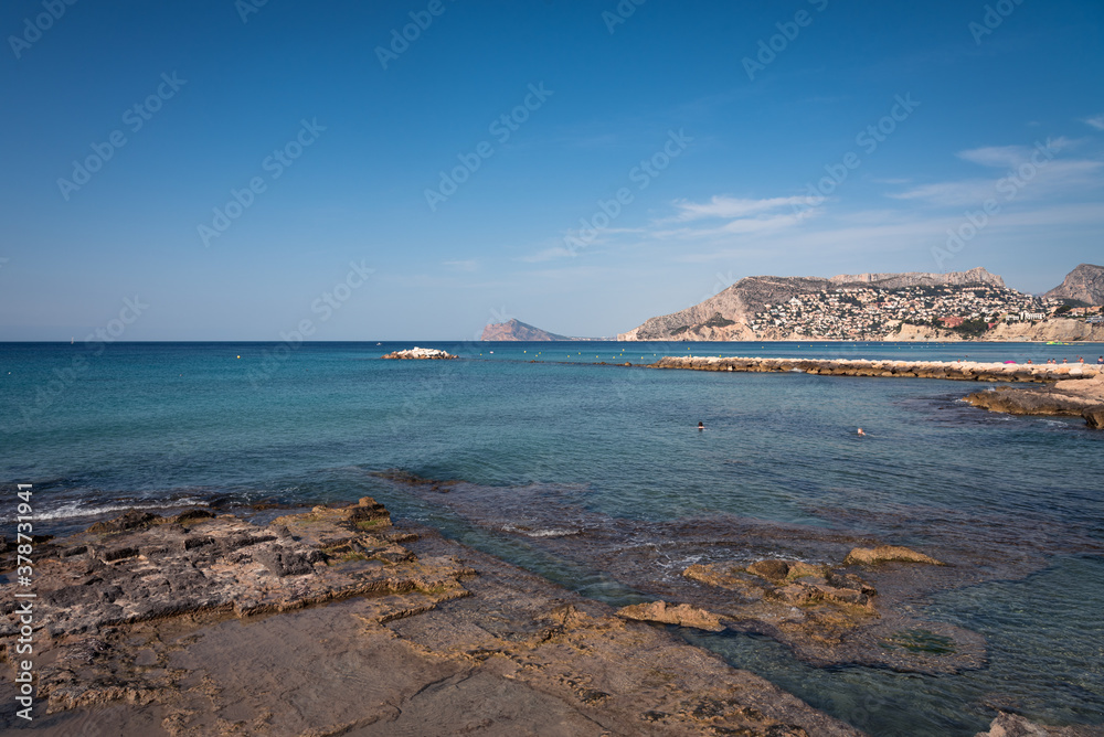 Seascape of the Calpe coastline with an urban rocky beach, Alicante, Spain Seascape of the Calpe coastline with an urban rocky beach, Alicante, Spain