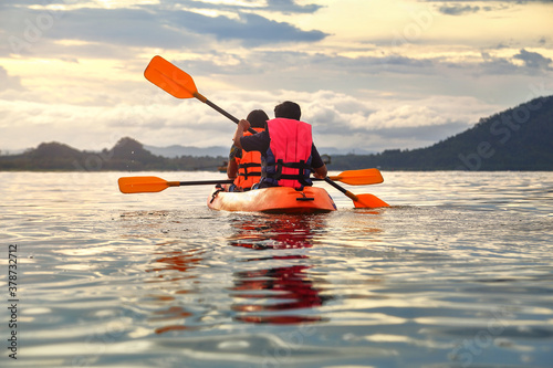 Tourist paddling the kayak on the sea among the beautiful scenery during sunset at koh pitak , chumphon province in Thailand. This is very popular for photographers and tourists. photo