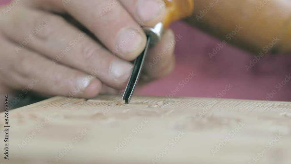 close-up. carpenter makes wood carving with a chisel and mallet. Carpentry, craftsmanship, design, manufacturing concept. close-up. carpenter makes wood carving with a chisel and mallet. Carpentry, craftsmanship, design, manufacturing concept.