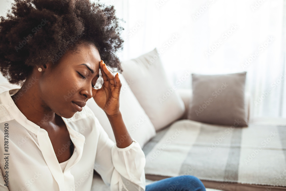 Sad tired young woman touching forehead having headache migraine or depression, upset frustrated girl troubled with problem feel stressed cover crying face with hand suffer from grief sorrow concept