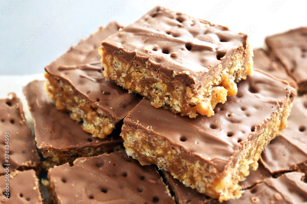 Chocolate rice crispy cake on white. Copy space is on the left side. Chocolate rice crispy cake on white. Copy space is on the left side.