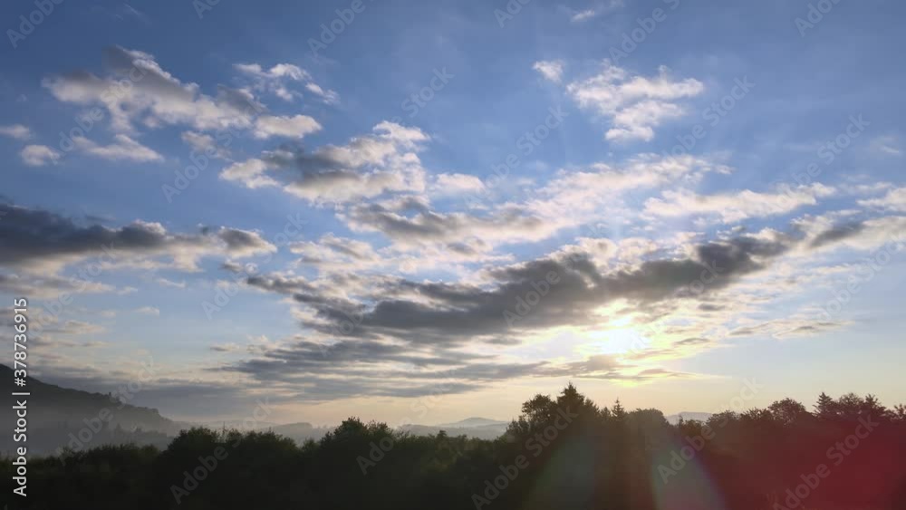 Golden hour clouds slowly drifting over forest, 4K HDR panoramic