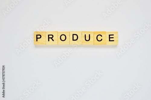 Word produce. Wooden blocks with lettering on top of white background. Top view of wooden blocks with letters on white surface