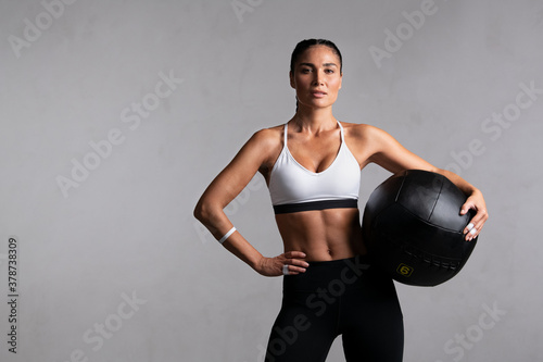 Determined fitness woman on grey background