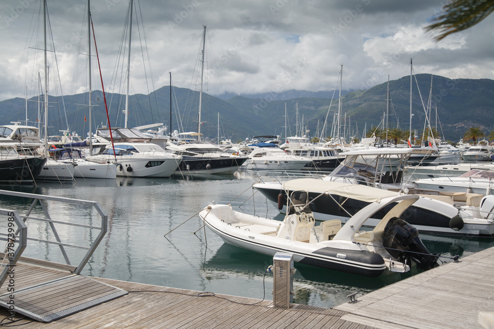 Landscape with an embankment, a pier and moored yachts, Montenegro, the city of Tivat.