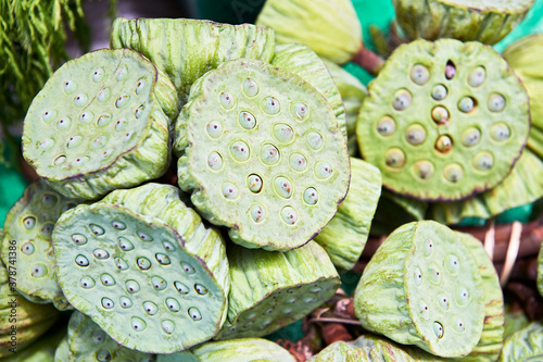 A close-up isolated view of a pile of green lotus seed heads of water lilies for sale at the Klong Toey Market in Bangkok, Thailand, Asia photo