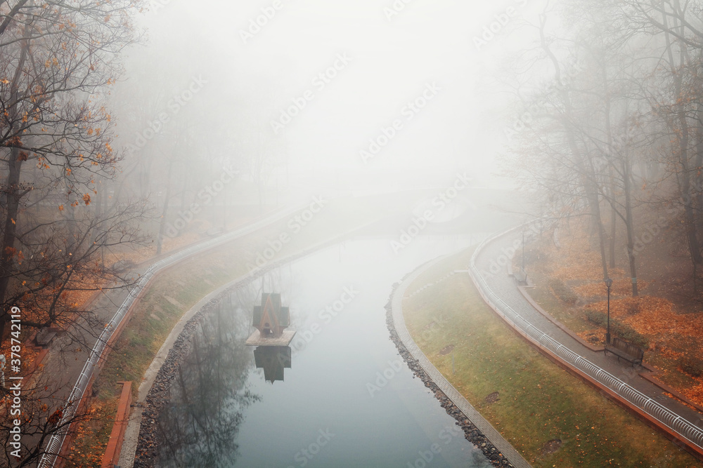 autumn pond Cozy alley in a city foggy park in the fall. Gomel, Belarus