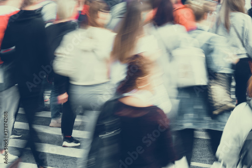 Blurred crowds of people walking around the city