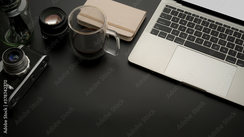 Worktable with laptop, camera, coffee cup, supplies and copy space Worktable with laptop, camera, coffee cup, supplies and copy space