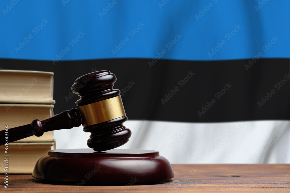Justice and court concept in Republic of Estonia. Judge hammer on a flag background