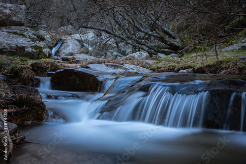 River water flows among the rocks and forms small waterfalls, Rascafría, Madrid, Spain