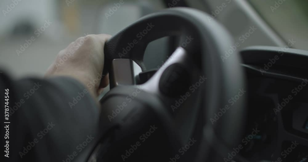 man steering a wheel while driving a car man steering a wheel while driving a car