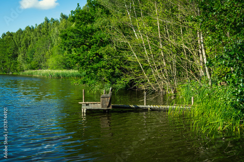 Wooden fishing jetty on a small forest lake