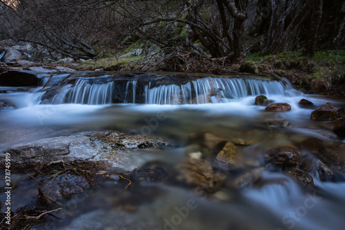 River water flows among the rocks and forms small waterfalls  Rascafr  a  Madrid  Spain