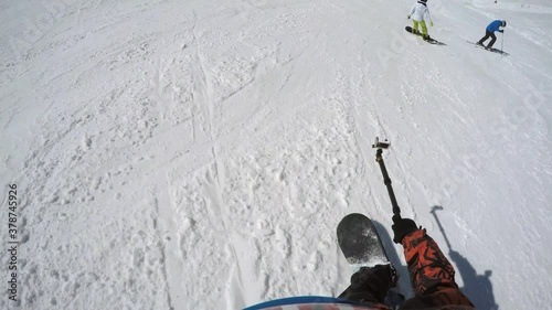 FPV boarder with action cam on monopod slides down and makes comment to another