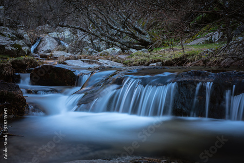 River water flows among the rocks and forms small waterfalls  Rascafr  a  Madrid  Spain