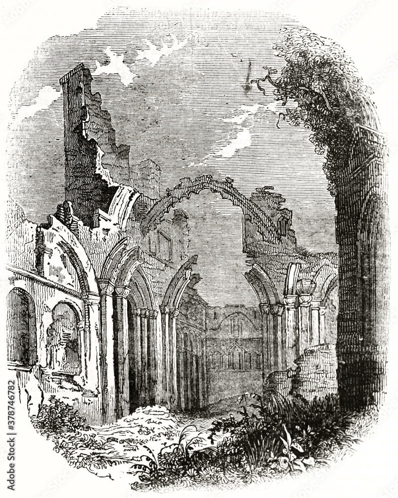 Old gothic ruins raising alone from vegetation. Lindisfarne priory ...