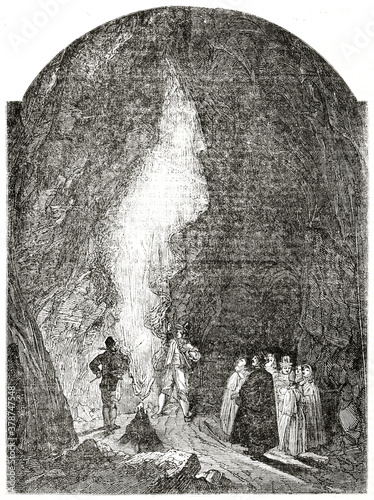 People inside dark Postojna Cave, Slovenia. Ancient engraving grey tone art by unidentified author, The Penny Magazine, London 1837 photo