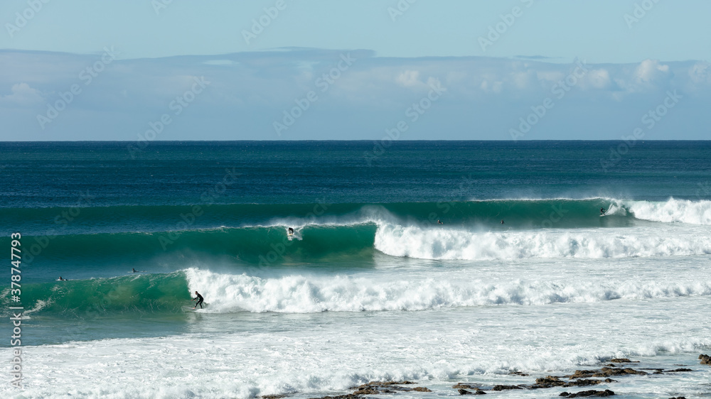 Beautiful view of three waves breaking on the beach at Jeffreys Bay, South Africa