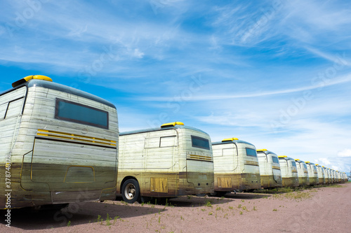 Row of camper vans in sunny weather. Roadside motel from camper. © olgavisavi