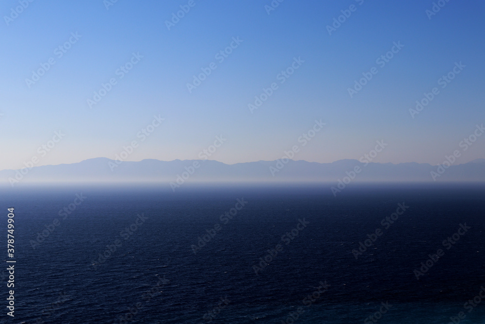 Sea with mountains background