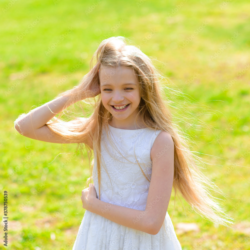 Beautiful blue-eyed girl with long blond hair in white dress walking in garden. Beautiful blue-eyed girl with long blond hair in white dress walking in garden.