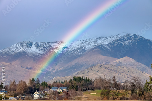 Bright rainbow in the mountains of Queenstown, New Zealand