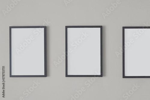 Elegant empty photo frames for text or images on a wall. Wedding or birthday invitation.