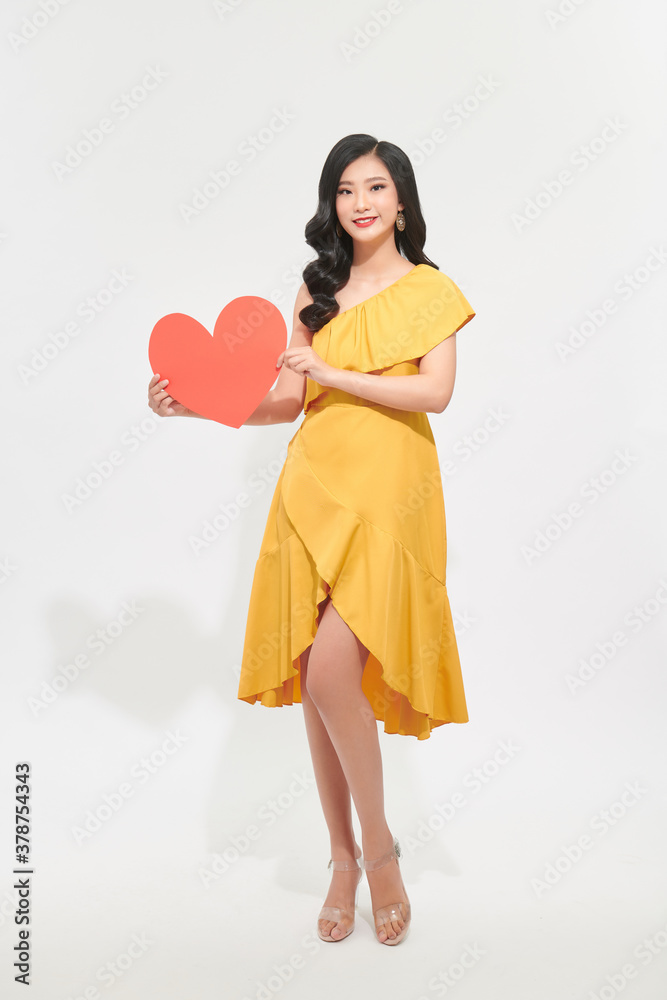 Portrait of attractive, pretty lady look at camera make hold paper red heart in hands isolated on shine teal background Portrait of attractive, pretty lady look at camera make hold paper red heart in hands isolated on shine teal background