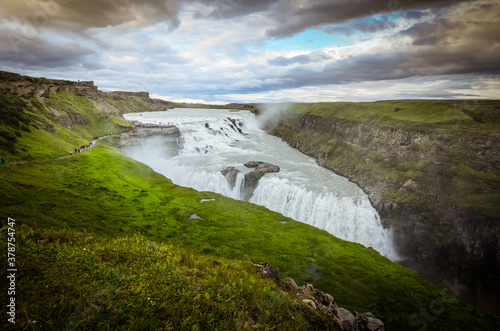 The photo shows Gullfoss. Beautiful wide waterfall in Iceland.