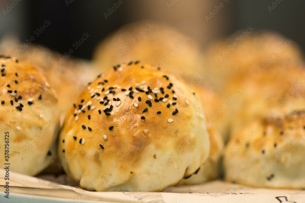 Bukharian (Uzbek) traditional pastries, stuffed with lamb meet and onion, with sesame and nigella