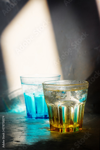 Glass of water on arustic backreound. with lighting effects photo