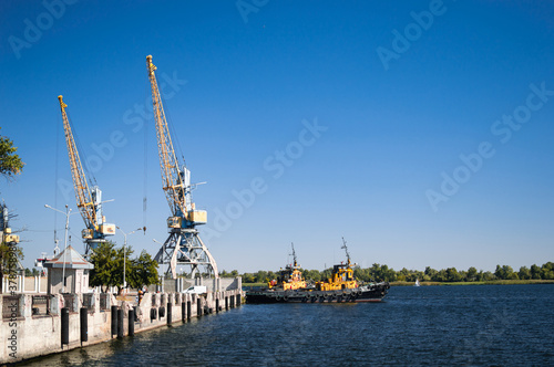 River port of the city of Kherson with cranes and ships.