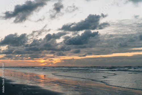  Sea landscape, Seascape, sunset, beautiful orange cloud sky, Reflections in the wet sand and waves washing up, Ameland, Wadden Island, nature conservation area, Friesland, The Netherlands © David Peperkamp