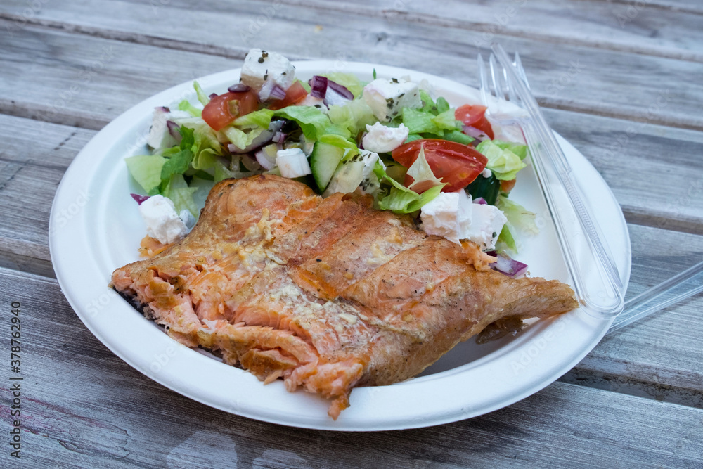 Delicious hungarian street food - smoked salmon fillets with greek salad