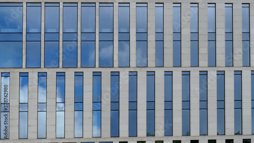 Exterior of a high-rise multi-story apartment building - facade, windows and balconies.