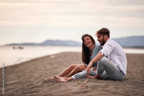 Young lovers sitting on the beach