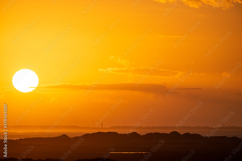 Sunrise in the beautiful protected nature area Het Oerd on the Wadden island of Ameland in the Netherlands, beautiful golden light in the early morning